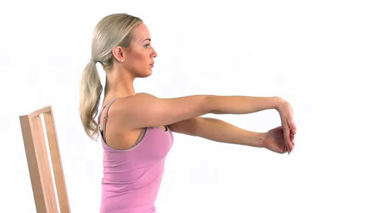 A woman performing wrist flexor stretches